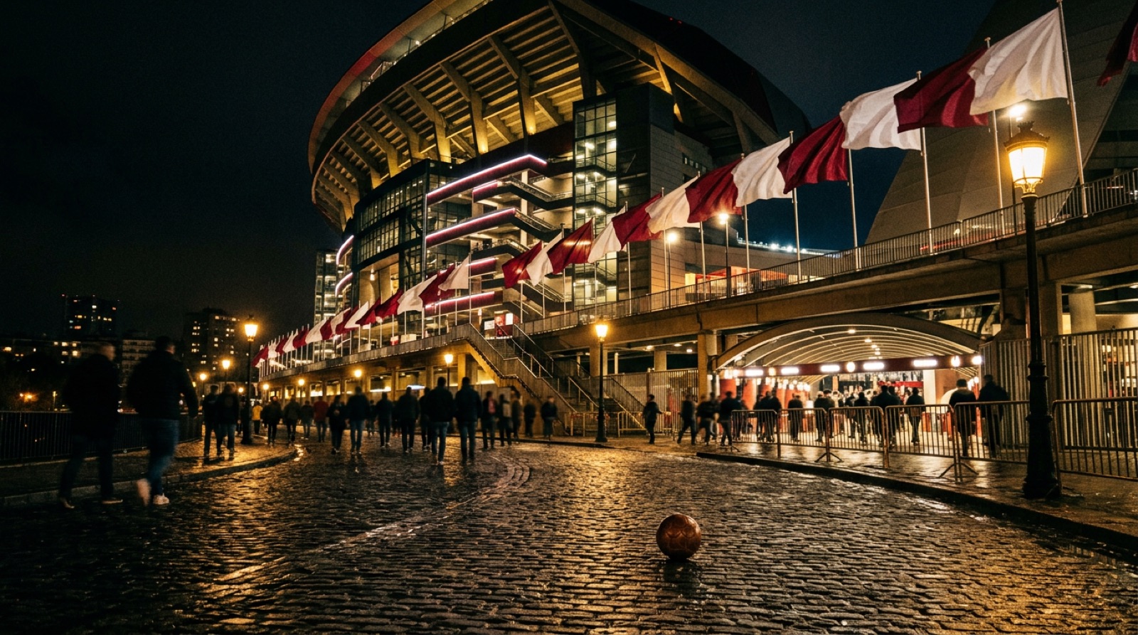 Esterno di uno stadio spagnolo in notturna con bandiere biancorosse
